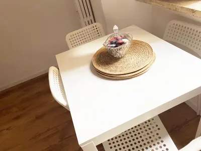 a white table with a bowl of fruit on it at Germanico Apartments in Rome