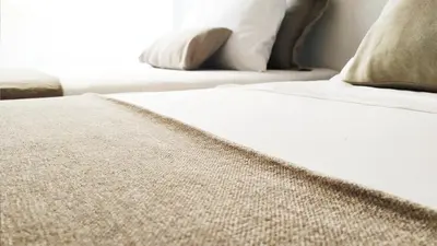 a bed with white sheets and pillows in a bedroom at Germanico Apartments in Rome