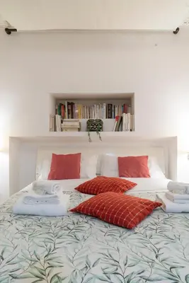 a bedroom with a bed with red pillows on it at Casa De' Medici in via Giulia in Rome
