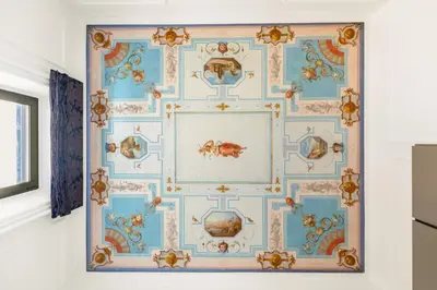 a room with a blue and gold wallpaper at Charm and Elegance by The Spanish Steps in Rome