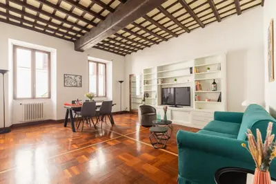 a living room with a green couch and a table at Campo de Fiori Large and Beautiful Apartment in Rome