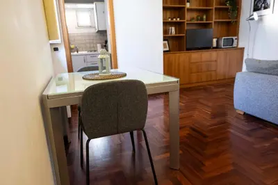 a table and a chair in a living room at FRAM Apartment Fori Imperiali in Rome