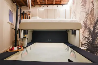 a room with a bed and a swimming pool at Suite del Grillo - Fori Imperiali - Il Nido d'Amore in Rome