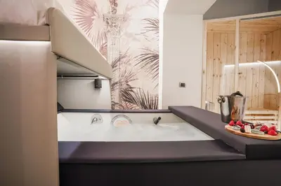 a bathroom with a bath tub with a sink at Suite del Grillo - Fori Imperiali - Il Nido d'Amore in Rome