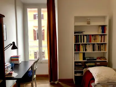 a bedroom with a book shelf filled with books at Large apartment in Rome city center in Rome