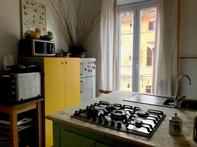 a kitchen with a stove and a yellow refrigerator at Large apartment in Rome city center in Rome