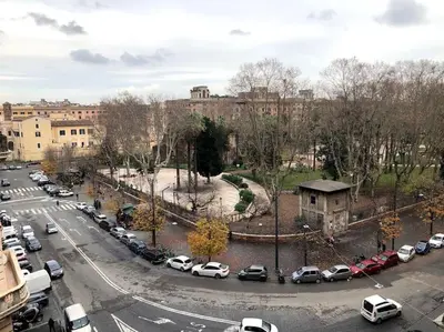 a city street with cars parked in a parking lot at Large apartment in Rome city center in Rome