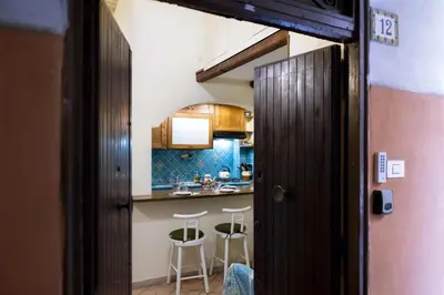 a kitchen with a counter and stools in a room at CircusMaximus n.3 in Rome