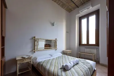 a bedroom with a bed with two towels on it at CircusMaximus n.3 in Rome