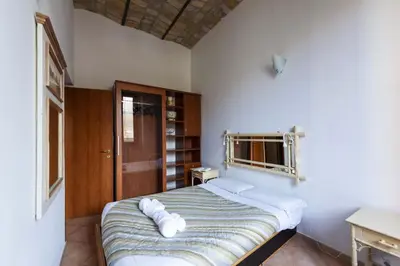a bedroom with a bed with white pillows on it at CircusMaximus n.3 in Rome