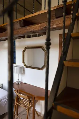 a bedroom with a desk and a mirror on a wall at CircusMaximus n.3 in Rome