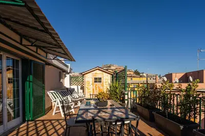 a patio with a table and chairs on a balcony at 4BNB - Loft del Papa in Rome