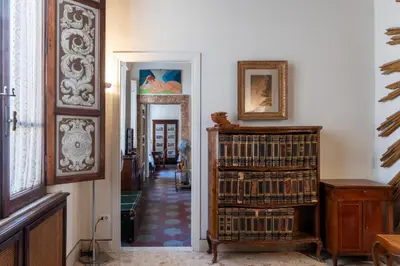 a hallway filled with lots of books at GuestHost - Pantheon Apartment - L'angolo nascosto dei quadri in Rome