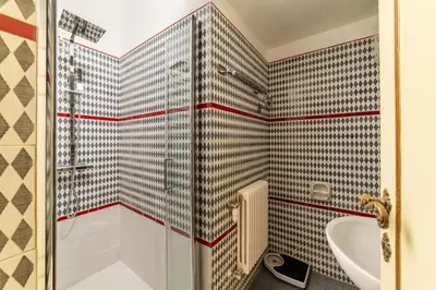 a bathroom with a shower and a tub at GuestHost - Pantheon Apartment - L'angolo nascosto dei quadri in Rome