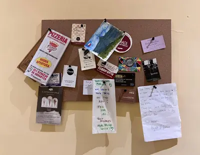 a table topped with lots of notes on a bulletin board at M&M Pigneto Roma in Rome