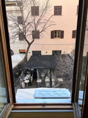 a view from a window of a table and umbrella at M&M Pigneto Roma in Rome