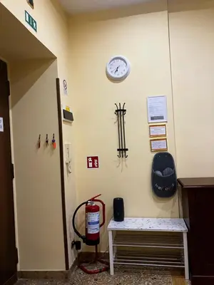 a room with a clock on a wall with a bench at M&M Pigneto Roma in Rome