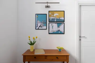 a room with a table and pictures on the wall at iFlat Navona Cozy Apartament in Rome