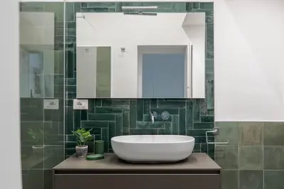 a bathroom with a white sink and a mirror at iFlat Navona Cozy Apartament in Rome