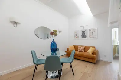 a living room with a table and chairs and a couch at iFlat Navona Cozy Apartament in Rome