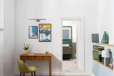 a white room with a desk and a mirror at iFlat Navona Cozy Apartament in Rome