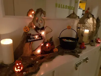 a counter with halloween decorations and candles on it at Rose Antiche Vatican B&B in Rome