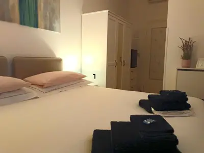 a white bed with two towels on top of it at Rose Antiche Vatican B&B in Rome