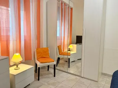 a room with a mirror and a chair and a desk at Vaticano - 5 min da stazione in Rome