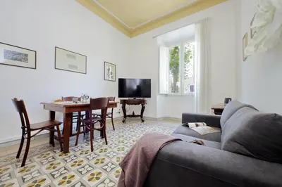 a living room with a couch and a table at Cozy Merulana in Rome