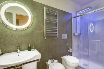 a bathroom with a sink and a toilet and a mirror at Excellence Suite in Rome