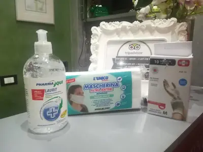 a bathroom counter with a bottle of detergent and a box of contraception at Excellence Suite in Rome