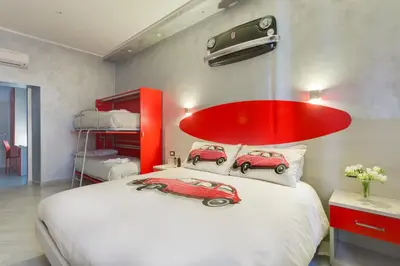 a bedroom with two toy cars on a bed at Excellence Suite in Rome