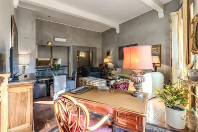 a kitchen with a counter with stools in it at Stylish 2 BDR Apt with Balcony by Pantheon & Forum in Rome