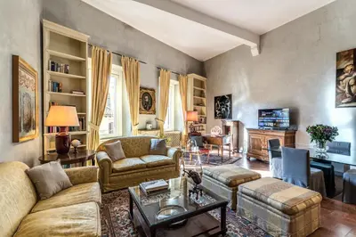 a red couch in a room with red curtains at Stylish 2 BDR Apt with Balcony by Pantheon & Forum in Rome