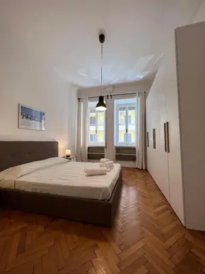 a bedroom with a large bed and a wooden floor at Flaminia@213 in Rome
