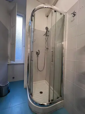 a shower with a glass door in a bathroom at Flaminia@213 in Rome