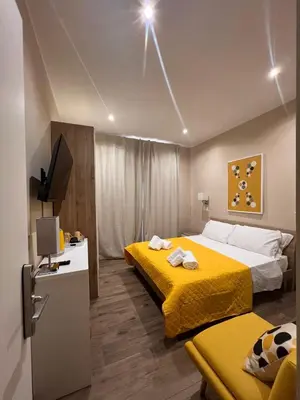 a hotel room with two beds and a television at Cozy Luxury Room Turati in Rome