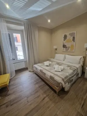 a bedroom with a large bed with two towels on it at Cozy Luxury Room Turati in Rome