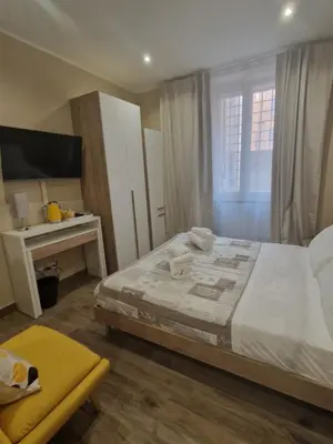 a bedroom with a large bed and a desk at Cozy Luxury Room Turati in Rome
