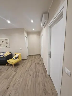 an empty living room with a couch and a door at Cozy Luxury Room Turati in Rome