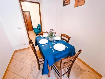 a dining room with a blue table and chairs at Vatican Shelter in Rome