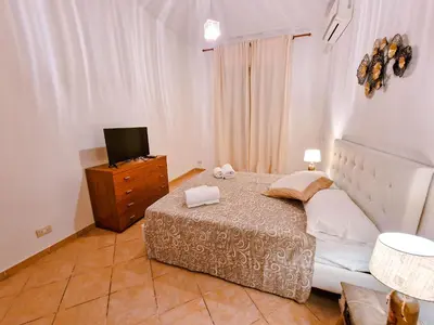 a bedroom with a bed and a dresser with a television at Vatican Shelter in Rome