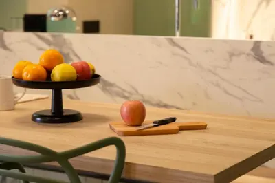 a bowl of fruit on a table with a knife at Loft Bianca Mano in Rome