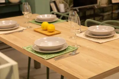 a wooden table with plates and wine glasses on it at Loft Bianca Mano in Rome