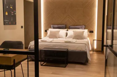 a bedroom with a large bed and a table at Loft Bianca Mano in Rome
