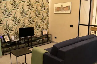 a living room with a couch and a tv at Loft Bianca Mano in Rome