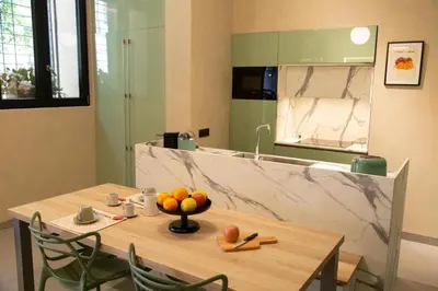 a kitchen with a table with a bowl of fruit on it at Loft Bianca Mano in Rome