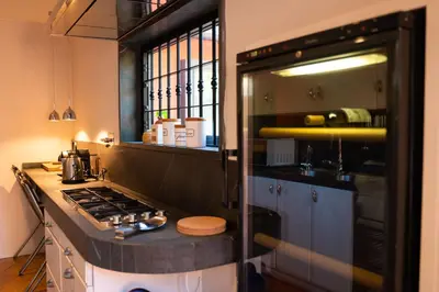 a kitchen with a stove and a counter top at Villa Terme di Caracalla with private Swimming Pool in Rome
