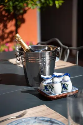 a bucket sitting on top of a table with a plate at Villa Terme di Caracalla with private Swimming Pool in Rome