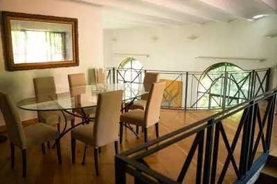a dining room with a glass table and chairs at Villa Terme di Caracalla with private Swimming Pool in Rome